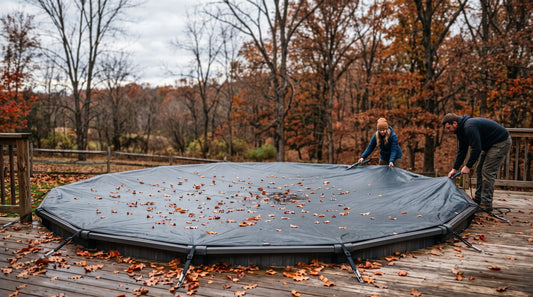 An above-ground pool covered for winter with fallen autumn leaves