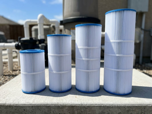 Four pool filter cartridges of different sizes on a daylight equipment pad